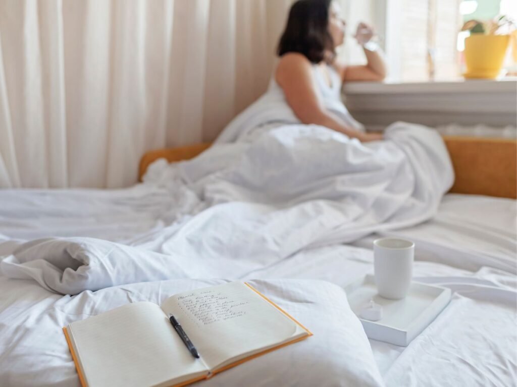 woman peacefully starting their day without a smartphone, surrounded by calming elements like a book, a cup of tea, and sunlight streaming through a window